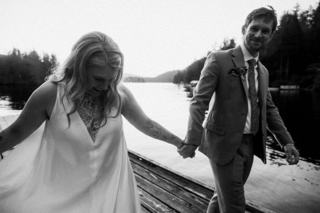 Candid black and white photo on a dock for neurodivergent weddings, celebrating authentic connection.
